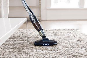 scopa elettrica che pulisce un tappeto con pelo lungo
